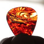 Guitar pick held up to light