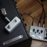 Footswitch on top of amp with guitar pedal on the floor